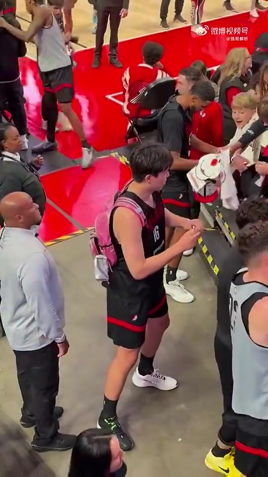 還不太熟練的樣子楊瀚森背著粉色包包給球員通道球迷簽名